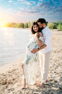 Zwangerschapsshoot op het strand met romantische dubbele belichting van verliefd stel in boho stijl