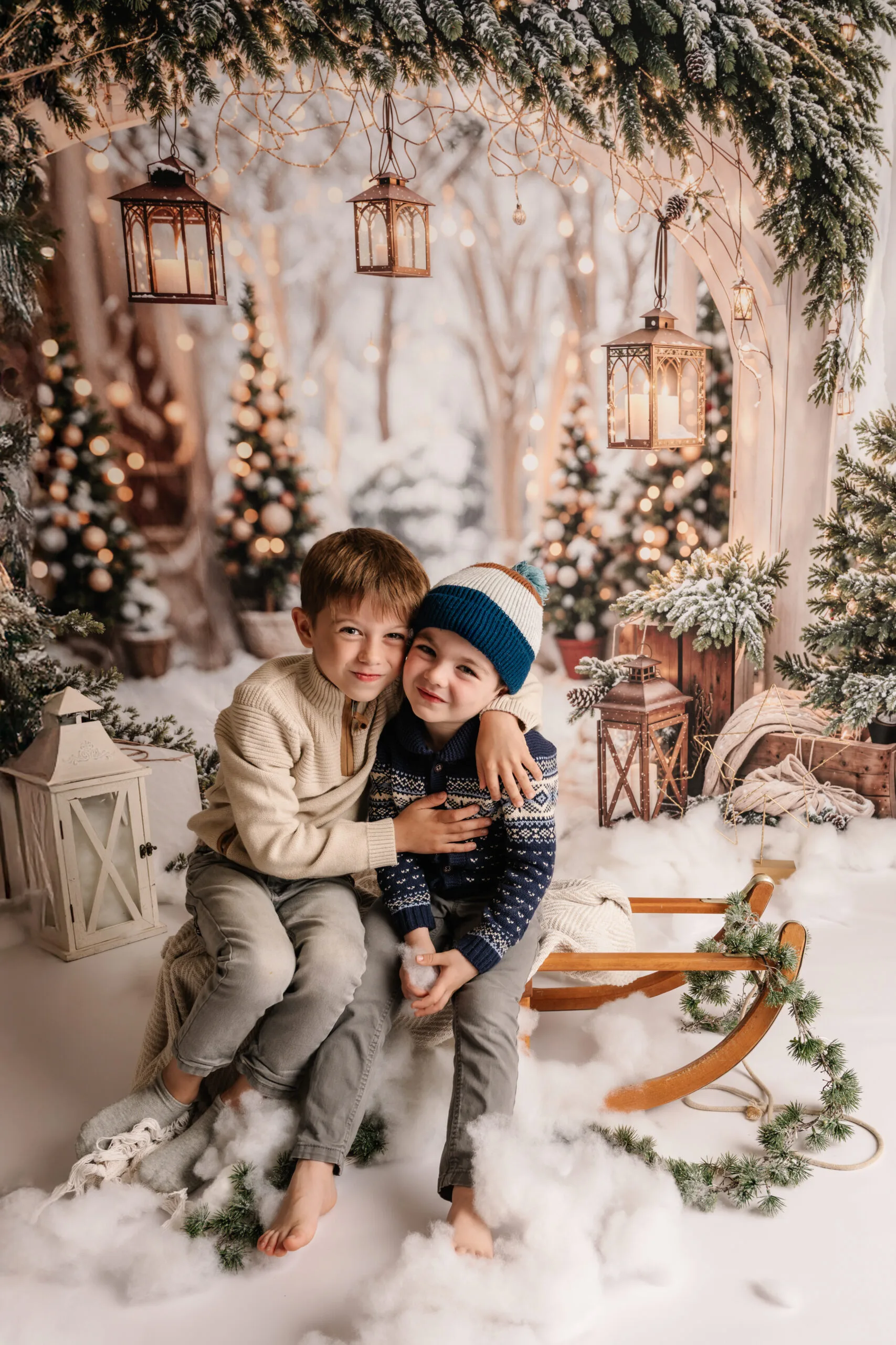 Twee jonge jongens in winterkleding op een slee in een knus kerstdecor met gloeiende lantaarns en feestelijke versiering